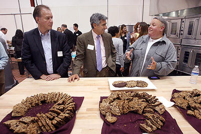 Tia Meyer of the San Lorenzo Valley, talks about her three-chocolate cookies with pecans and brown sugar at Monday's grand opening of El Pajaro Community Development Corporation's incubator commercial kitchen in Watsonville. (Dan Coyro/Sentinel) ( Dan Coyro )
